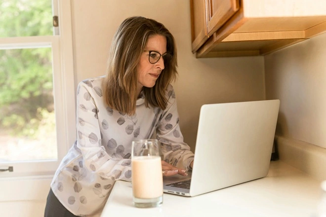 Lady using a laptop.